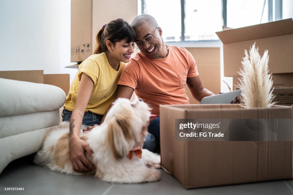 Young couple packing and moving boxes at home
