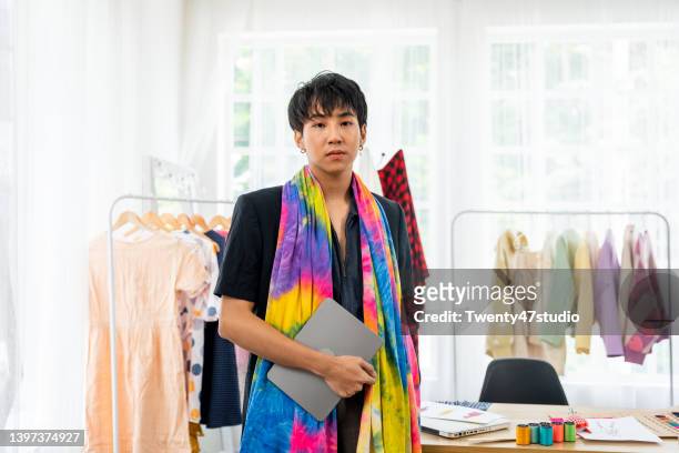 portrait of asian young gay fashion designer in his studio. - fashion stylist stock pictures, royalty-free photos & images