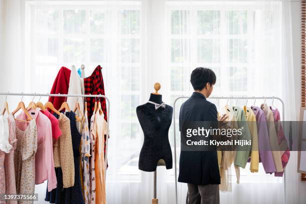 asian gay fashion designer working in his studio. - stylist bildbanksfoton och bilder