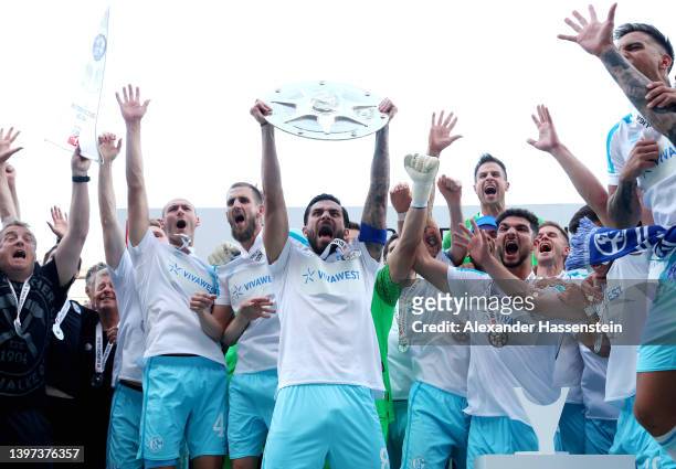 Danny Latza of FC Schalke 04 lifts The Meisterschale trophy after winning the 2. Bundesliga after their sides victory in the Second Bundesliga match...
