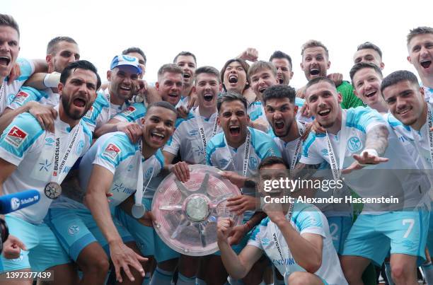 Players of FC Schalke 04 pose for a photograph with the The Meisterschale trophy after winning the 2. Bundesliga after their sides victory in the...