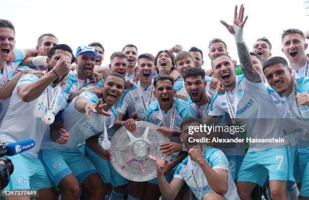 Players of FC Schalke 04 pose for a photograph with the The Meisterschale trophy after winning the 2. Bundesliga after their sides victory in the...