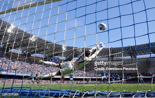 Salvatore Sirigu of Genoa CFC attempts to stop the ball as Lorenzo Insigne of SSC Napoli scores their side's second goal from a penalty during the...