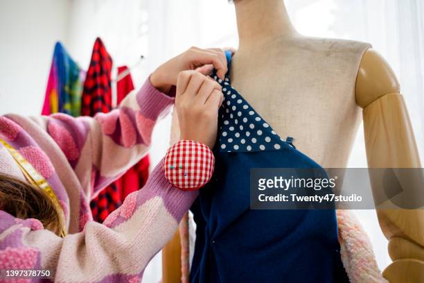 asian young female fashion designer making a dress in the clothing design studio. - dressmakers model stock pictures, royalty-free photos & images