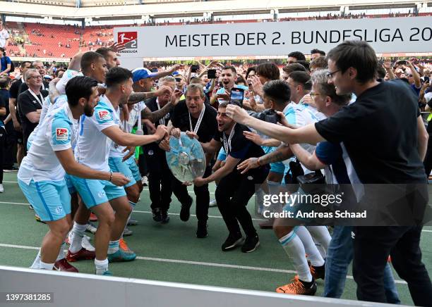 Mike Buskens, Manager of FC Schalke 04, lifts with The Meisterschale trophy after winning the 2. Bundesliga after their sides victory in the Second...