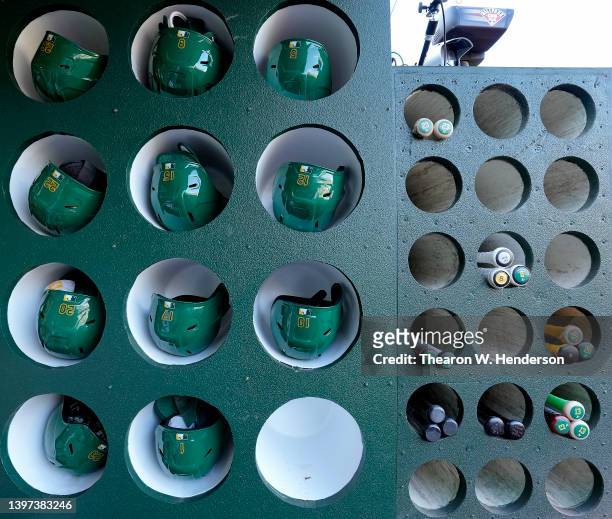 Detailed view of the helmets and bats belonging to the Oakland Athletics seen in the racks prior to their game against the Los Angeles Angels at...