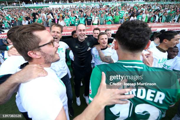 Ole Werner, Manager of SV Werder Bremen, celebrates as players of SV Werder Bremen huddle as they celebrate after securing promotion to the Budesliga...