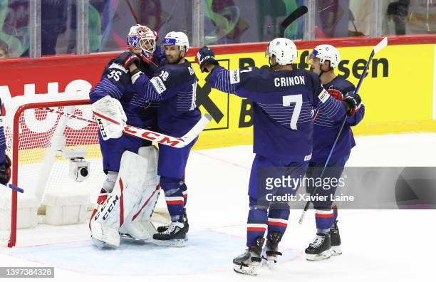Henri Corentin Buysse of Team France celebrate the victory with Yoahann Auvitu and teammates after the 2022 IIHF Ice Hockey World Championship Group...