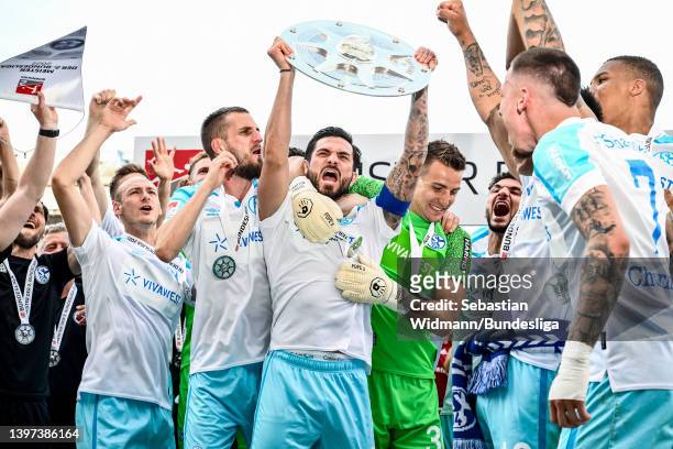 Danny Latza of Schalke lifts the Meisterschale trophy during the Second Bundesliga match between 1. FC Nürnberg and FC Schalke 04 at...
