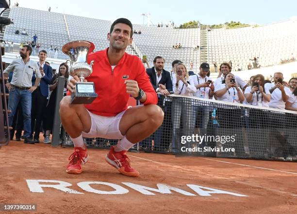 Novak Djokovic of Serbia celebrates with the Internazionali BNL D'Italia Men's Single's winners trophy after his victory against Stefanos Tsitsipas...