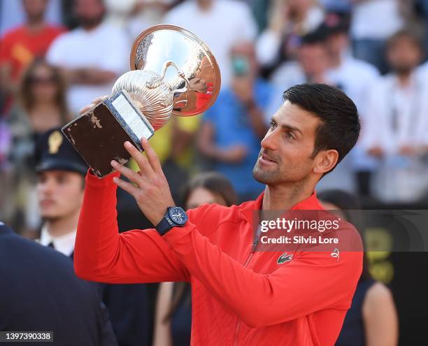 Novak Djokovic of Serbia celebrates with the Internazionali BNL D'Italia Men's Single's winners trophy after his victory against Stefanos Tsitsipas...