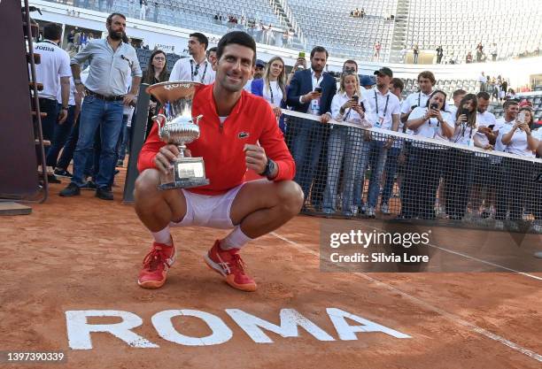 Novak Djokovic of Serbia celebrates with the Internazionali BNL D'Italia Men's Single's winners trophy after his victory against Stefanos Tsitsipas...