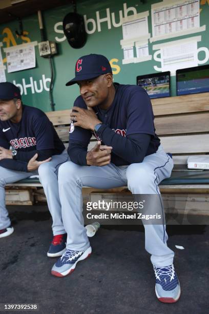 First Base Coach Sandy Alomar Jr. #15 of the Cleveland Guardians in the dugout before the game against the Oakland Athletics at RingCentral Coliseum...
