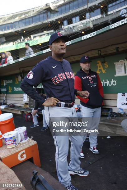 First Base Coach Sandy Alomar Jr. #15 of the Cleveland Guardians in the dugout before the game against the Oakland Athletics at RingCentral Coliseum...