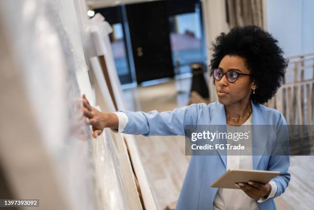 young woman using the digital tablet at architects' studios - project management stock pictures, royalty-free photos & images