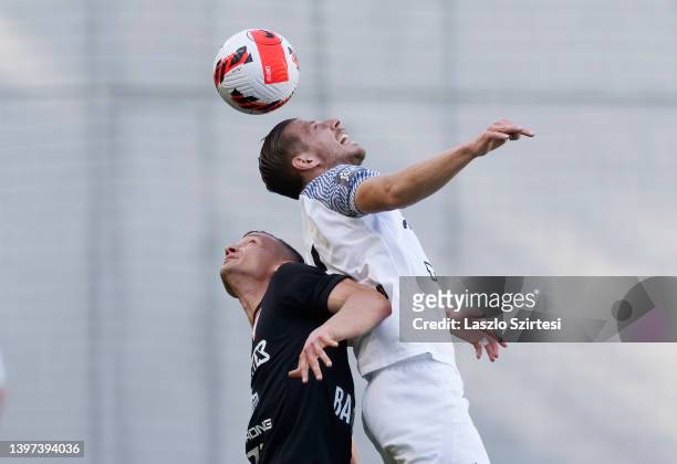 Ylber Ramadani of MTK Budapest battles for the ball in the air with David Babunski of DVSC during the Hungarian OTP Bank Liga match between MTK...
