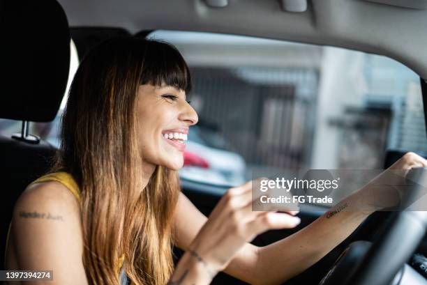 happy young woman driving car - driver's seat stock pictures, royalty-free photos & images