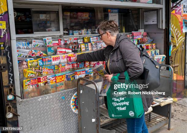 Woman buys Polish language magazines May 3, 2022 at a newsstand in the Greenpoint neighborhood of New York City. The Polish community in Greenpoint...