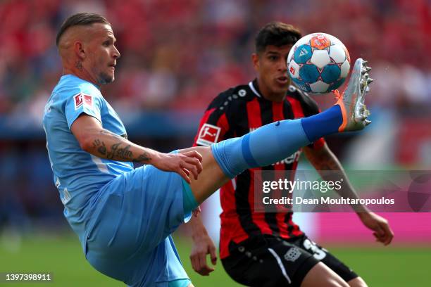 Jonathan Schmid of Sport-Club Freiburg battles for the ball with Piero Hincapie of Bayer 04 Leverkusen during the Bundesliga match between Bayer 04...