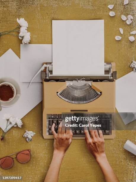 conceptual image of female hands typing in old typewriter  with blank papermessy creative desktop top view - spanish literature stock pictures, royalty-free photos & images