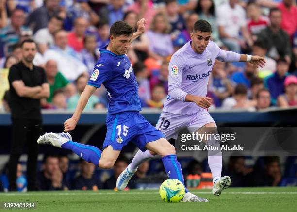 Jorge Cuenca of Getafe CF battles for possession with Ferran Torres of FC Barcelona during the LaLiga Santander match between Getafe CF and FC...