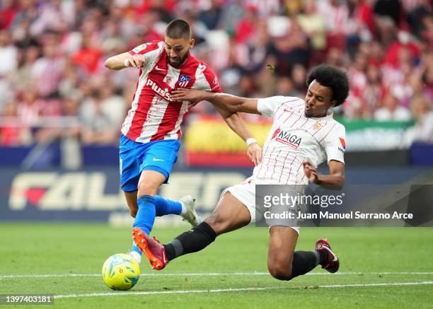 Yannick Ferreira Carrasco of Atletico Madrid battles for possession with Jules Kounde of Sevilla during the LaLiga Santander match between Club...
