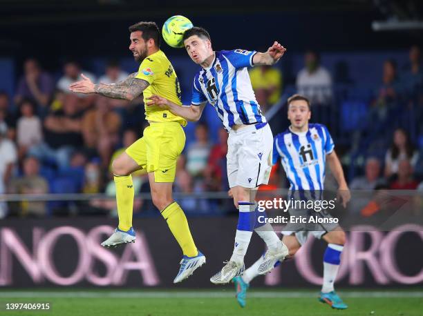Paco Alcacer of Villarreal CF challenges for the high ball with Igor Zubeldia of Real Sociedad during the LaLiga Santander match between Villarreal...