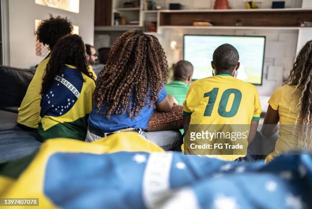 friends watching soccer match together at home - international soccer event stock pictures, royalty-free photos & images