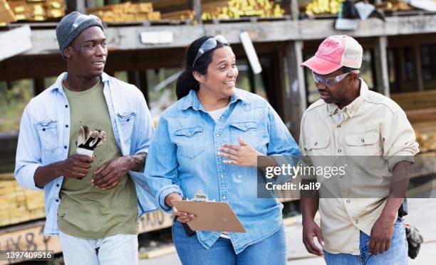 woman, two men, working at lumberyard, conversing - casual clothing store stock pictures, royalty-free photos & images