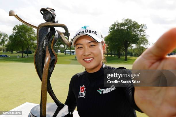 Minjee Lee of Australia imitates a "selfie" with the trophy after sinking a putt for birdie on the 18th green to win during the final round of the...
