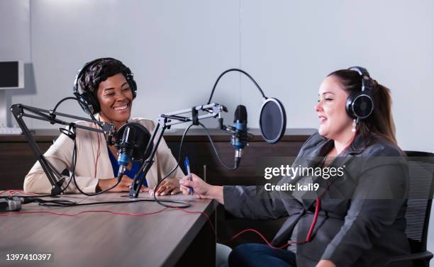 two multiracial women recording a podcast - radio host imagens e fotografias de stock