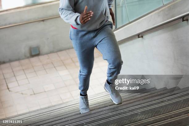 african-american man running up concrete staircase - 9 steps stock pictures, royalty-free photos & images