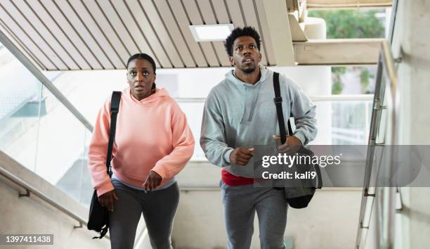 african-american couple climbing stairs, look lost - looking around stock pictures, royalty-free photos & images