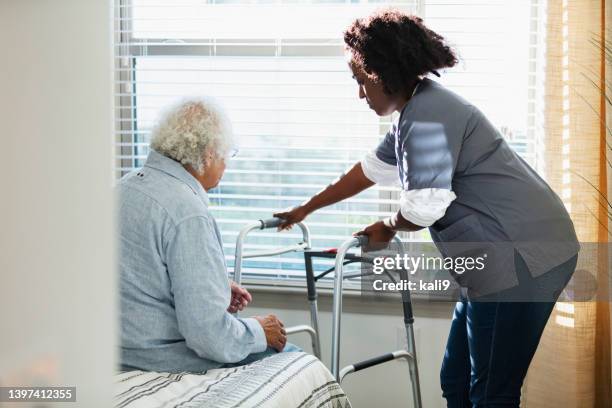 home healthcare worker helps senior man with walker - on the outside looking in stock pictures, royalty-free photos & images