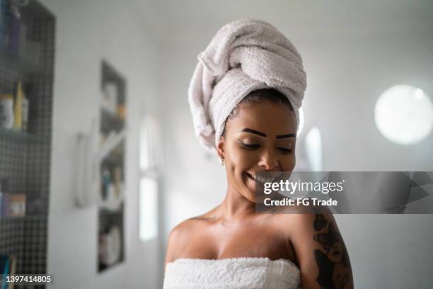 young woman after shower at home - mirror steam stockfoto's en -beelden