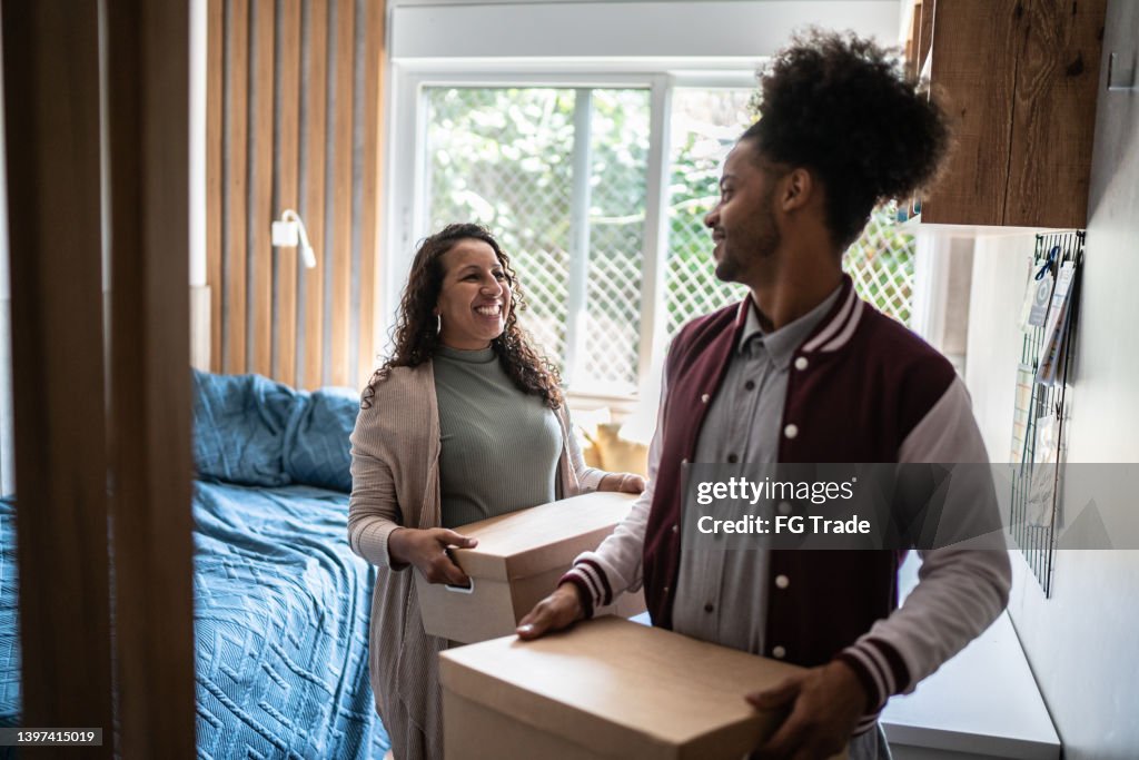 Parents Help Move Out Mother Helping Son Carrying Moving Boxes To Move Out From Parents Home ...