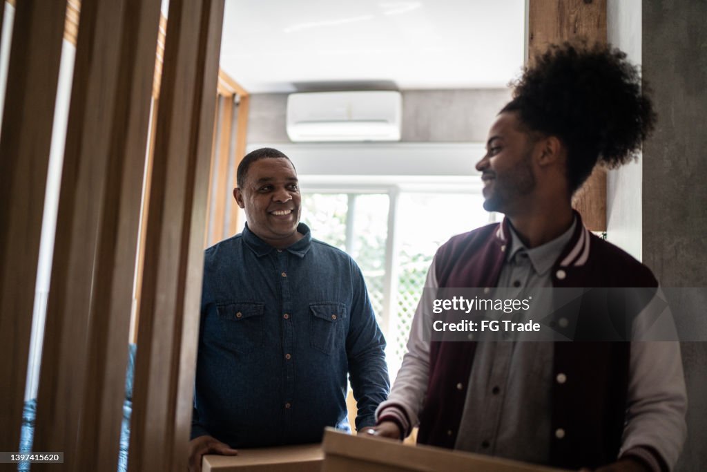 Parents Help Move Out Father Helping Son Carrying Moving Boxes To Move Out From Parents Home ...