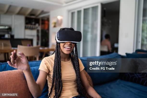 teenage girl playing using vr glasses at home - voice remote stock pictures, royalty-free photos & images