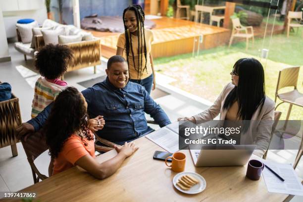 transgender professional consultant doing a meeting with a family during home visit - family decisions stock pictures, royalty-free photos & images