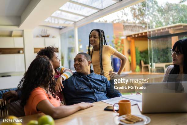 transgender professional consultant doing a meeting with a family during home visit - family decisions stock pictures, royalty-free photos & images