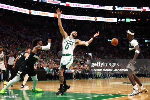 Jayson Tatum of the Boston Celtics loses the ball as he drives to the basket against Wesley Matthews of the Milwaukee Bucks during the second quarter...