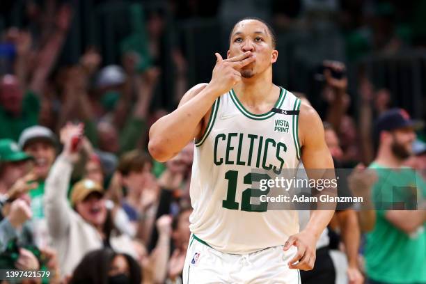 Grant Williams of the Boston Celtics reacts after making a three point basket during the third quarter against the Milwaukee Bucks in Game Seven of...