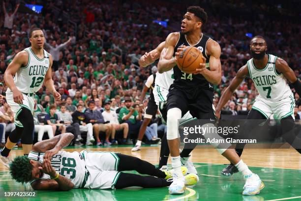 Giannis Antetokounmpo of the Milwaukee Bucks drives to the basket against Marcus Smart of the Boston Celtics during the third quarter in Game Seven...