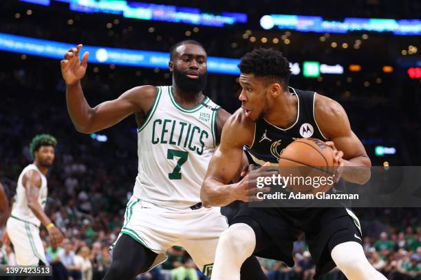 Giannis Antetokounmpo of the Milwaukee Bucks handles the ball against Jaylen Brown of the Boston Celtics during the third quarter in Game Seven of...