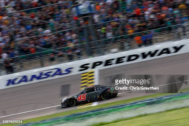 Kurt Busch, driver of the Jordan Brand Toyota, crosses the finish line to win the NASCAR Cup Series AdventHealth 400 at Kansas Speedway on May 15,...