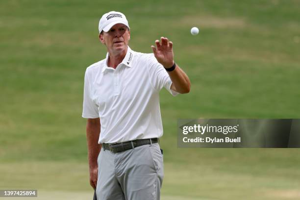 Steve Stricker receives his ball from his caddie on the 16th green during the final round of the Regions Tradition at Greystone Golf and Country Club...