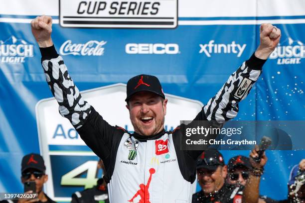 Kurt Busch, driver of the Jordan Brand Toyota, celebrates in victory lane after winning the NASCAR Cup Series AdventHealth 400 at Kansas Speedway on...