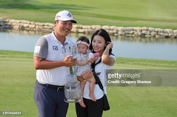 Lee of South Korea poses with the trophy and his Wife Joo Yeon Yu and daughter Celine Yuna after winning on the 18th green during the final round of...