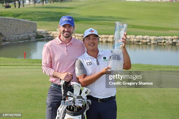 Lee of South Korea poses with the trophy and his caddie Dan Parratt after winning on the 18th green during the final round of the AT&T Byron Nelson...