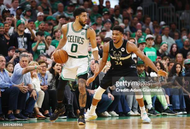 Jayson Tatum of the Boston Celtics handles the ball against Giannis Antetokounmpo of the Milwaukee Bucks during the fourth quarter in Game Seven of...